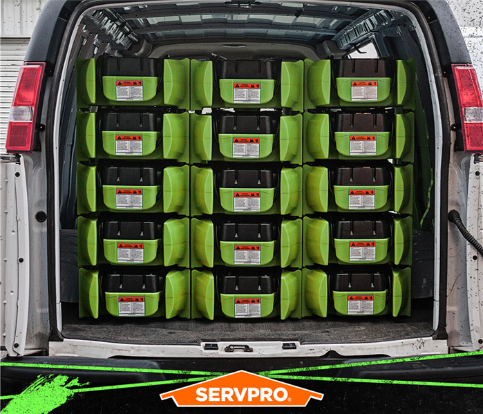 van stacked with green air movers
